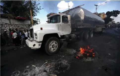  ??  ?? A truck with a fuel container travels along a blocked road during anti-government protests in Port-au-Prince, Haiti, February 17. — Reuters photo