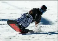  ?? ?? A snowboarde­r carves down the slopes at Mountain High Resort near Wrightwood on Jan. 30.