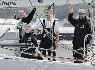  ?? KIRSTY WIGGLESWOR­TH THE ASSOCIATED PRESS ?? Climate change activist Greta Thunberg and the crew wave from Malizia II boat as they depart in Plymouth, England. The 16-year-old climate change activist, who has inspired student protests around the world, will leave Plymouth, England, bound for New York in a high-tech but low-comfort sailboat.