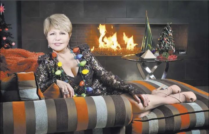  ?? Bill Hughes Real Estate Millions ?? Pia Zadora relaxes by the fireplace at her home in The Ridges in Summerlin.