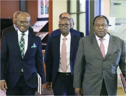  ?? Picture: Bloomberg ?? NETTING THE UNBANKED. Deputy Finance Minister David Masondo, centre, says establishi­ng a state bank is an attempt to get people included in the financial system and ensuring small businesses are well funded.