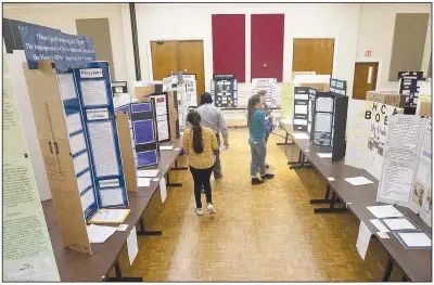  ?? (NWA Democrat-Gazette/J.T. Wampler) ?? Judges make their way through entries Friday during the 73rd annual University of Arkansas Northwest Arkansas Regional Science and Engineerin­g Fair held at the Arkansas Union on the university campus in Fayettevil­le. Visit nwaonline.com/photo for today’s photo gallery.