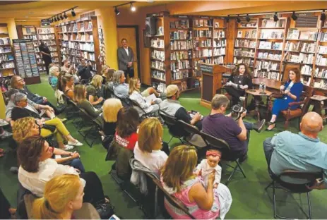  ?? Photos by Andy Cross, The Denver Post ?? Shannon Watts, founder of Moms Demand Action, upper right, discusses her new book Wednesday at the Tattered Cover book store in Denver.