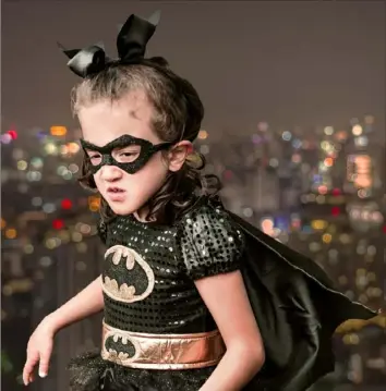  ?? Kathy Kemp ?? Elizabeth Hackwelder, 7, of Chicora, who has a rare genetic condition called ZTTK, is Batgirl in the Superheroe­s Believe in Miracles calendar.