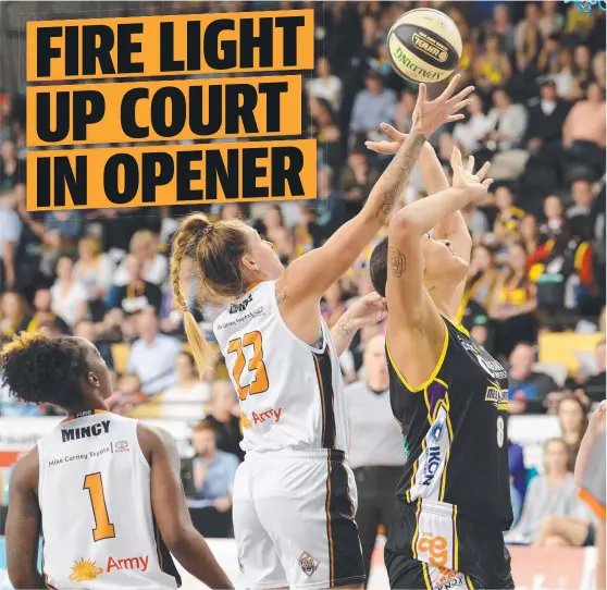  ?? STARRING ROLE: Townsville star Cayla George grabs a rebound over Boomers centre Liz Cambage in the Fire’s win in Melbourne. Picture: LAWRENCE PINDER ??