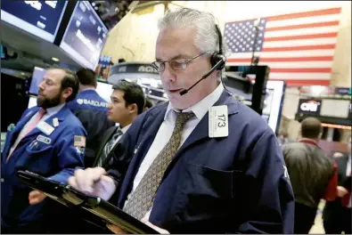  ?? AP/RICHARD DREW ?? Trader Frank O’Connell works Wednesday on the floor of the New York Stock Exchange. The 2016 sell-off in U.S. stocks intensifie­d, with the Dow Jones industrial average tumbling more than 360 points.