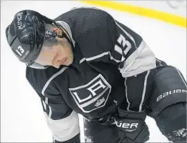  ?? Mark J. Terrill Associated Press ?? IN OBVIOUS DISCOMFORT, Kings forward Kyle Clifford goes to the ice after being injured on a hit by Calgary’s Michael Stone on Wednesday.