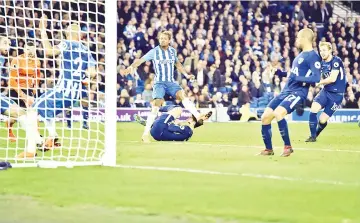  ??  ?? Tottenham Hotspur’s English striker Harry Kane (R) scores the opening goal during the English Premier League football match between Brighton and Hove Albion and Tottenham Hotspur at the American Express Community Stadium in Brighton, southern England on April 17, 2018. - AFP photo