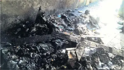  ??  ?? Debris left by children who set fires in bins before pelting rubbish at firefighte­rs