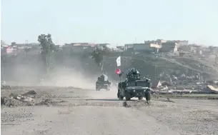  ?? Florian Neuhof for The National ?? Iraqi federal police drive along the perimeter of Mosul airport.