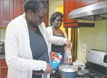  ??  ?? Ebele (right) cooks with her mother at home.