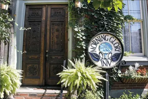  ?? Darrell Sapp/Post-Gazette photos ?? Ferns, ivy and begonias grow in front of the 1862-built house that became the Morning Glory Inn on the South Side.