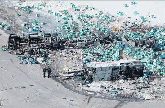  ?? JONATHAN HAYWARD THE ASSOCIATED PRESS ?? Emergency personnel work at the scene of a fatal crash outside Tisdale, Sask. A bus carrying the Humboldt Broncos collided with a transport truck, killing 16 and injuring a dozen more on April 6.