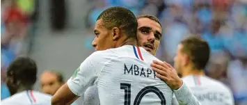  ?? Foto: Charisius/dpa ?? Zwei Superstars, ein Ziel: Kylian Mbappe gratuliert Antoine Griezmann zu seinem Treffer gegen Uruguay.