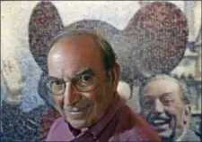  ?? JAE C. HONG — THE ASSOCIATED PRESS FILE ?? In this file photo, Martin “Marty” Sklar, Imagineeri­ng Vice Chairman and Principal Creative Executive, poses in front of a picture of Mickey Mouse and Walt Disney at Disneyland in Anaheim Sklar, one of the central figures behind Disney’s theme parks...