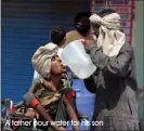  ?? A father pour water for his son ??