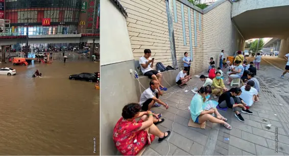  ??  ?? People charge their phones outside a restaurant after flooding caused power outages at their homes