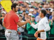  ??  ?? Rickie Fowler (right) shakes hands with Jon Rahm after finishing one stroke behind Patrick Reed. Rahm shot 69 on Sunday to finish in fourth place.
