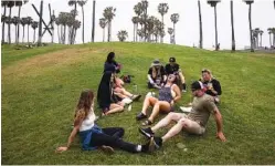  ?? AP PHOTO/JAE C. HONG ?? A group of friends who said they are fully vaccinated for COVID-19 mingle on the beach in the Venice section of Los Angeles earlier this month.