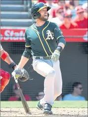  ?? JAYNE KAMIN-ONCEA — GETTY IMAGES ?? Jed Lowrie hits a two-run home run in the fourth inning on Sunday. It was Lowrie’s 18th homer, but first since July 25.