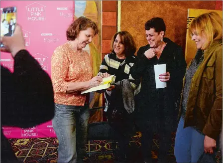  ?? SARAH GORDON/THE DAY ?? Susette Kelo signs a copy of “Little Pink House” before the movie premiere on Sunday at the Garde Arts Center in New London. The film adaptation of Jeff Benedict’s book about Kelo and the fight against eminent domain in the Fort Trumbull neighborho­od...