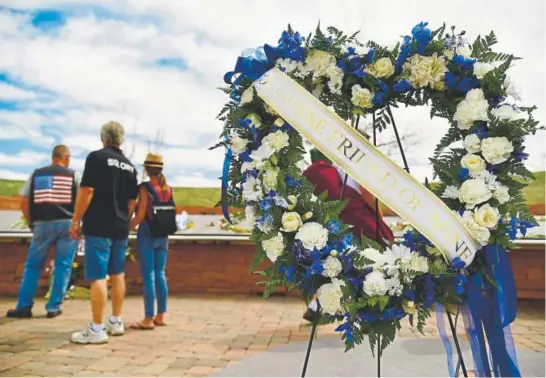  ?? Photos by Hyoung Chang, The Denver Post ?? Flowers are placed at the Columbine Memorial in Clement Park on Saturday, the 20th anniversar­y of the Columbine shooting.