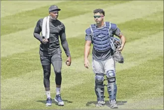  ?? Kathy Willens / Associated Press ?? Yankees’ lefty Aroldis Chapman, left, with catcher Gary Sanchez after a recent bullpen session, could be replaced by Zack Britton as closer if he is not back by the opener.