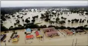  ?? ASSOCIATED PRESS ?? IN THIS AERIAL PHOTO, businesses and neighborho­ods near Addicks Reservoir are flooded by rain from Tropical Storm Harvey Tuesday in Houston.