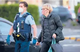  ?? FIONA GOODALL/GETTY ?? Police escort people from LynnMall to their cars after a lone individual stabbed six people before being shot by police Friday in Auckland, New Zealand.