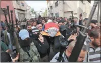  ?? ?? Palestinia­n mourners carry the body of a youth who was reportedly killed during a raid by Israeli forces on Monday in the West Bank city of Jenin.