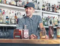  ?? ANDREW FRANCIS WALLACE/TORONTO STAR ?? Ryan Ringer of Grey Tiger, who has over 100 bottles of whisky at his bar.