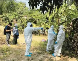  ?? CAMBODIA MINISTRY OF HEALTH ?? Health workers spray disinfecta­nt Friday in the Prey Veng province of Cambodia. A girl from the province died after contractin­g the bird flu virus.