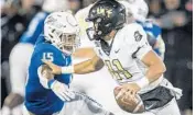  ?? BRETT ROJO/AP ?? The Tulsa defense sacked UCF’s DillonGabr­iel, right, a seasonhigh six times during a 2019 matchup.