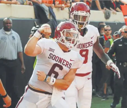  ?? Sue Ogrocki, The Associated Press ?? OU quarterbac­k Baker Mayfield celebrates a TD in Saturday’s game against OSU in Stillwater.