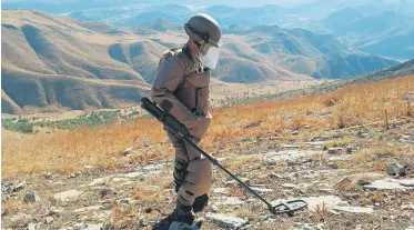  ?? ?? This photo shared by Ministry of Defense shows a soldier scanning for mines in an undisclose­d location.