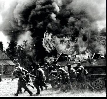  ??  ?? ABOVE German forces continue their advance into Russia, pushing through a burning village