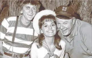  ?? The Associated Press file ?? Dawn Wells, center, with fellow cast members of “Gilligan’s Island,” Bob Denver and Alan Hale Jr., in 1965 in Los Angeles. Wells, who played wholesome Mary Ann on the 1960s sitcom, died Wednesday.