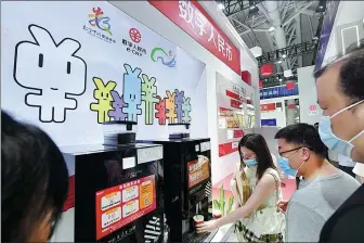  ?? LYU MING / CHINA NEWS SERVICE ?? Visitors pay for their coffee using e-CNY during an expo in Fuzhou, Fujian province.