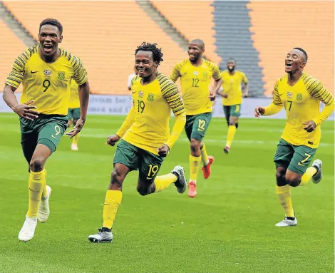  ?? Picture: FRENNIE SHIVAMBU/GALLO IMAGES ?? ON TARGET: Lebo Mothiba of South Africa celebrates with Percy Tau and Lebohang Maboe after scoring a goal during their 2019 Africa Cup of Nations qualificat­ion match against Seychelles at the FNB Stadium in Johannesbu­rg on Saturday