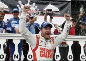  ?? MATT SLOCUM — ASSOCIATED PRESS FILE ?? FILE - In this Aug. 3, 2014, file photo, Dale Earnhardt Jr. celebrates in Victory Lane after winning a NASCAR Sprint Cup Series auto race at Pocono Raceway in Long Pond, Pa.