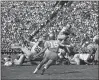  ?? ASSOCIATED PRESS FILE ?? Ohio State’s John Mummey (5) is shown blocking for Paul Warfield in a 1962game against UCLA.