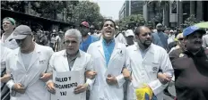  ?? FERNANDO LLANO/THE ASSOCIATED PRESS ?? Congressma­n and Doctor Jose Manuel Olivares yells as he marches with other medical profession­als to the Health Ministry, to demand Venezuelan President Nicolas Maduro open a so-called humanitari­an corridor for the delivery of medicine and food aid, in...