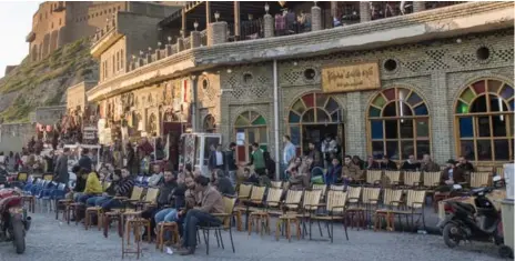  ?? RYAN REMIORZ/THE CANADIAN PRESS ?? Kurds sit at a tea shop under the historic citadel in Erbil, Iraq. Many Kurds are in favour of statehood, but not before achieving economic independen­ce.