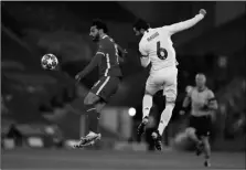  ?? AP Photo/Jon Super ?? Liverpool’s Mohamed Salah (left) jumps for the ball with Real Madrid’s Nacho during a Champions League quarter final second leg soccer match between Liverpool and Real Madrid at Anfield stadium in Liverpool, England, on Wednesday.