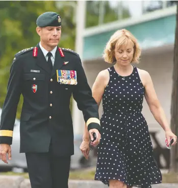  ?? JUSTIN TANG / THE CANADIAN PRESS ?? Maj.-gen. Dany Fortin walks with his wife Madeleine Collin as he arrives at the Gatineau police station Wednesday.