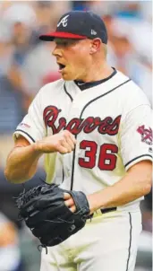  ??  ?? Atlanta Braves closer Mark Melancon pumps his fist after getting the final out in Sunday’s victory over the Los Angeles Dodgers.