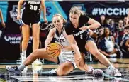  ?? David Becker/Associated Press ?? Gonzaga’s Eliza Hollingswo­rth and Portland’s McKelle Meek battle for a loose ball Tuesday.