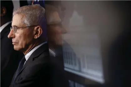  ??  ?? Dr. Anthony Fauci listens as President Donald Trump speaks during a coronaviru­s task force briefing at the White House. Photograph: Patrick Semansky/AP