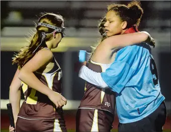  ?? TIM MARTIN/THE DAY ?? Stonington goalie Aliza Bell, right, is comforted by teammates Collette Dreher, center, and Mary Williams after the Bears were beaten by No. 1 North Branford 2-0 in Tuesday’s Class S field hockey semifinall­s.