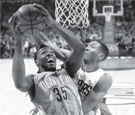  ??  ?? Nuggets forward Kenneth Faried tries to score against Clippers forward Wesley Johnson during the first half of Monday night’s game at the Staples Center in Los Angeles. Faried finished with eight points. Photos by Mark J. Terrill, The Associated Press